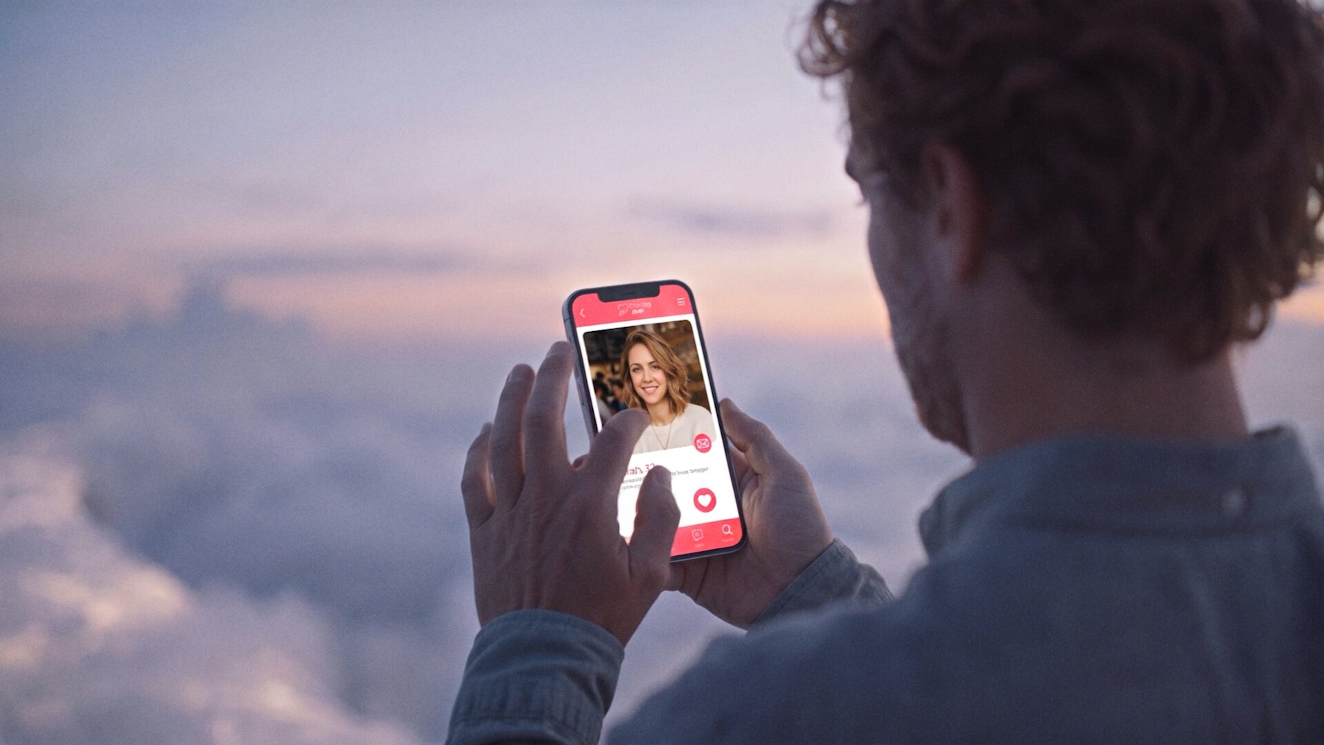 A man swipes through a dating app above the clouds