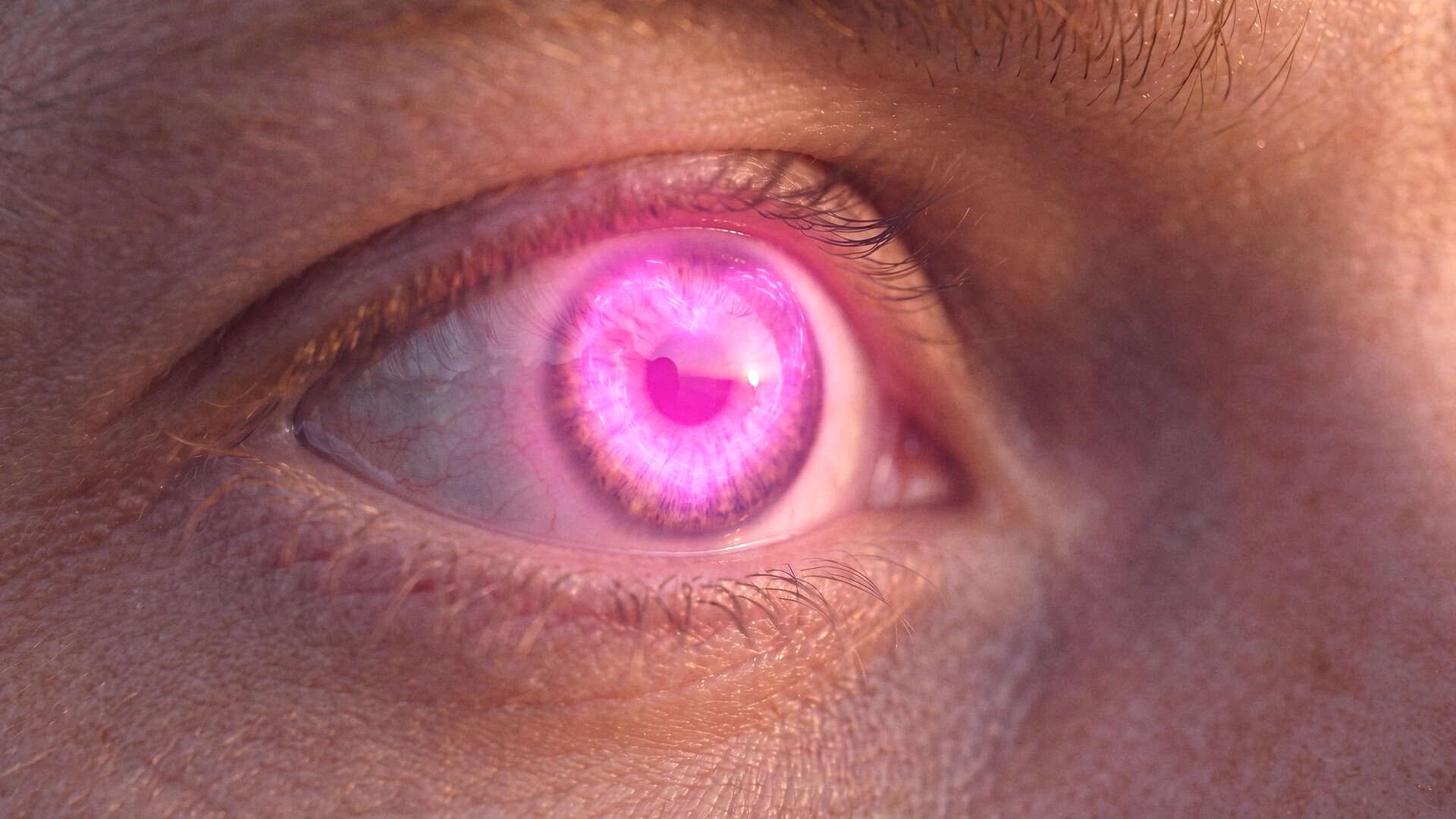 A macro of an eye with a glowing pink heart in the iris