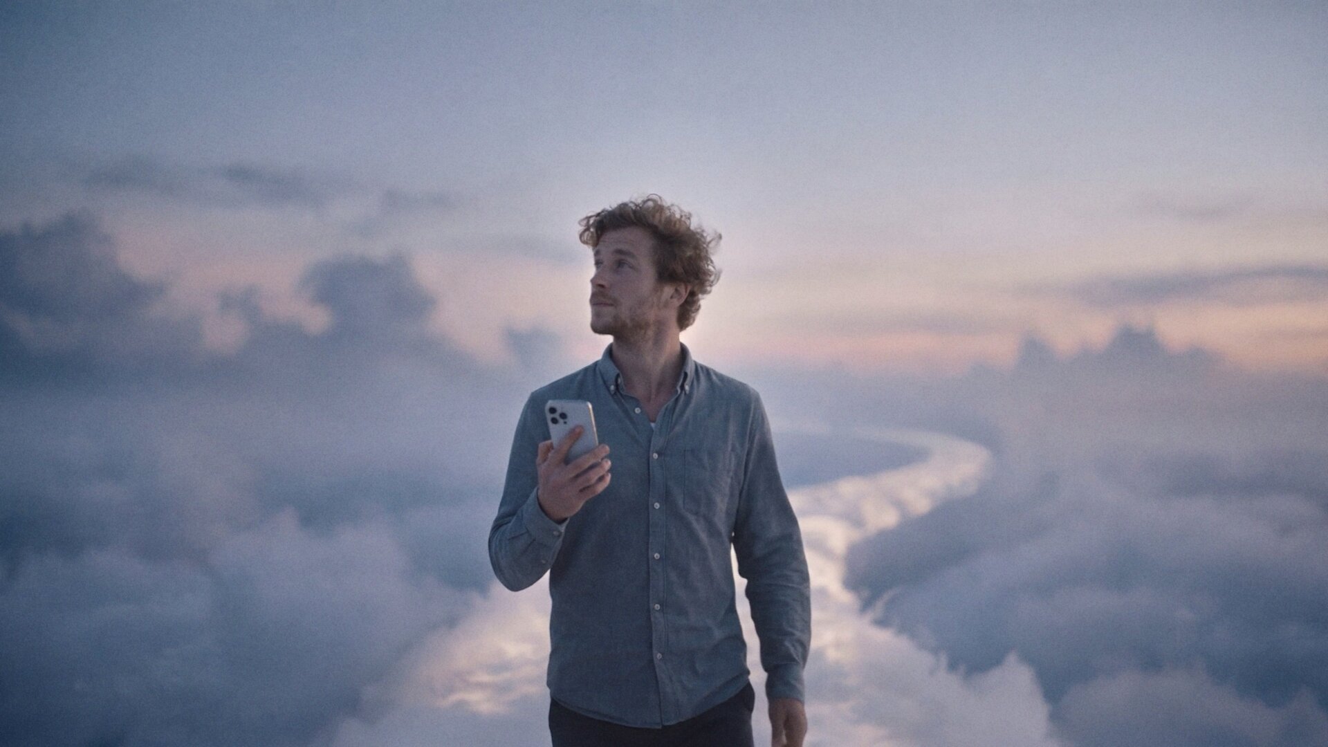 A man alone above the clouds, glowing with self-appreciation